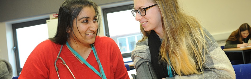 students smiling at each other